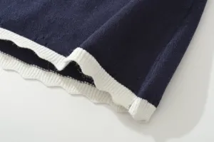Knit top fabric detail, elegant dark blue short sleeve top texture, breathable summer style.