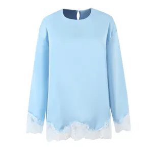 Close-up view of the light blue long sleeve top featuring delicate white lace trim details.