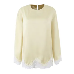 Elegant champagne long sleeve blouse with delicate white lace trim at hem and cuffs.