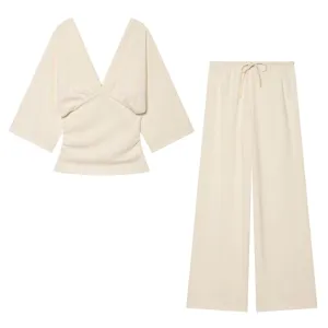 Beige two-piece women's set featuring a deep V-neck top and comfortable drawstring wide-leg pants.