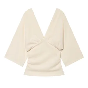 Beige deep V-neck short sleeve top detail featuring elegant front ruching and stylish design.