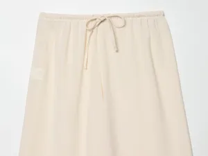 Beige lightweight women trousers detail shot featuring elastic drawstring waistband design.