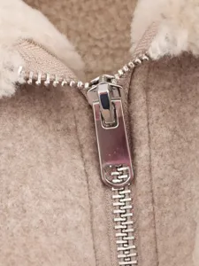Women shearling lapel wool jacket detail view, stylish autumn outerwear for modern ladies.