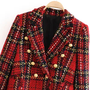 Detail view of red plaid tweed blazer featuring double breasted gold buttons and lapels.