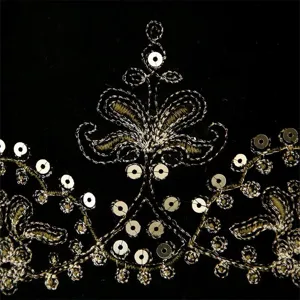 Close-up detail of women velvet vest featuring luxurious gold metallic sequin embroidery.