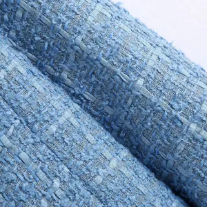 Detail shot of blue tweed fabric texture for women blazer, showing close-up woven details.