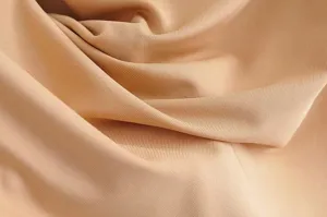 Close-up detail of smooth khaki bodysuit fabric showing delicate texture and drape.