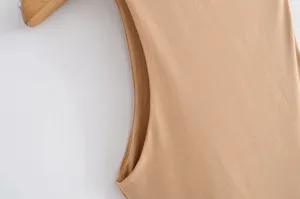 Detail shot of khaki sleeveless bodysuit armhole, smooth fabric texture, slim fit apparel.