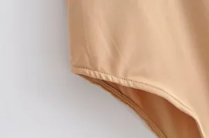 Solid color basic slim fit sleeveless bodysuit fabric detail shot with fine stitching.