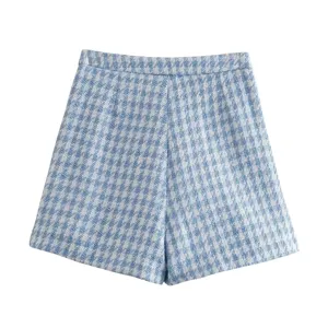 Blue and white houndstooth tweed shorts detail view, featuring classic pattern and fine texture.