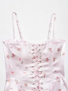 Pink satin floral corset top detail, lace-up front with metal grommets and adjustable straps.