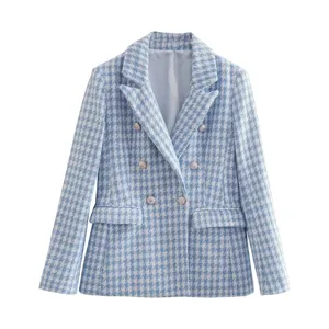 Close-up detail of the blue houndstooth tweed fabric, elegant lapel and metal buttons.