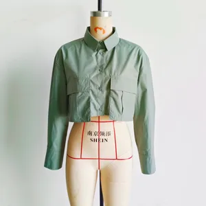 Light green cropped utility shirt for women, featuring long sleeves and chest pockets.