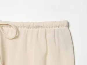 Beige summer women wide leg pants elastic drawstring waist detail close up lightweight fabric