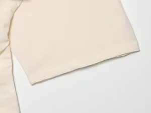 Close-up view of the smooth fabric and neat sleeve cuff of a summer women's short sleeve top.