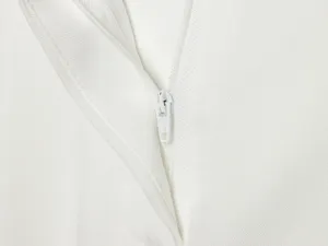 Close-up detail of white zipper on women clothing apparel summer fashion design fabric