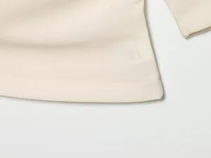 Close-up detail of the women summer solid color short sleeve top hem and neat stitching.