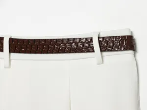 High waist summer shorts detail showing stylish brown textured belt and clean white fabric design.