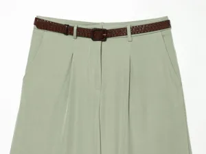 High-waist pleated women shorts detail view featuring stylish dark brown embossed belt design.