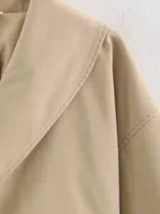 Close-up view of the chic lapel collar and fine stitching on this stylish short jacket.