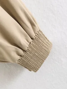Khaki jacket cuff detail, elegant elastic shirred wrist design, women fashion apparel close up