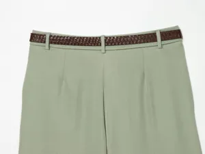 Close-up detail of women's sage green high waist shorts paired with a brown textured belt.