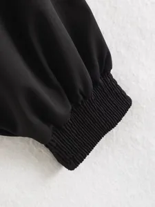 Black ribbed sleeve cuff detail of stylish outerwear, elegant texture and close-up view.