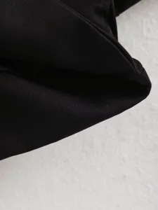 Detailed close-up view of black fabric texture for women's autumn short coat apparel design.