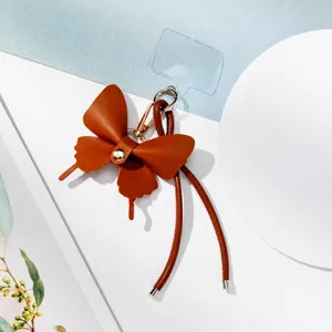 Encantador colgante de teléfono de cuero marrón y accesorio elegante de bolso para mujer.