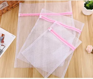 White mesh laundry bags set with pink zippers for delicate clothing protection and washing care.