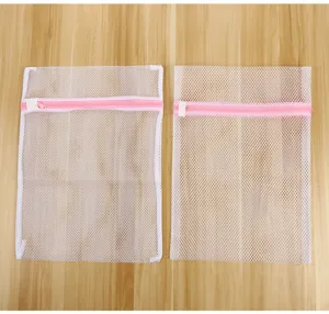White mesh laundry bags with pink zippers, durable washing bags for delicate clothes.