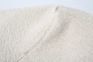 Textured fabric detail of the stylish woolen lapel pocket jacket coat for autumn winter.