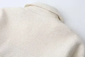 Close-up view of textured fabric and lapel collar on the casual women's winter jacket.
