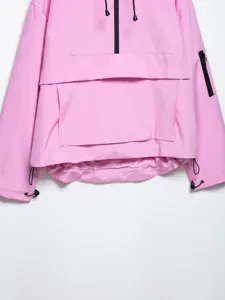 Close-up detail of the pink outdoor utility hooded jacket showing zipper pocket and hem cord.