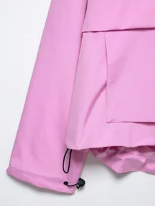 Pink outdoor utility jacket close-up detail, showing pocket and adjustable drawstring.
