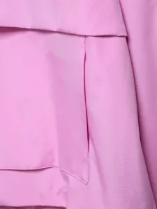 Pink outdoor utility jacket detail for women, featuring durable triple-proof fabric.