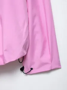 Detail view of women pink outdoor casual jacket sleeve with adjustable black drawstring.