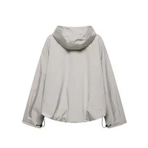 Detail view of a casual light grey hooded windbreaker jacket with drawstring hem.
