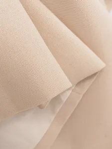 Beige fabric detail closeup, premium woven suit material texture for women's fashion apparel.