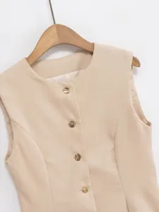Detailed view of beige sleeveless vest featuring round neckline and gold buttons.