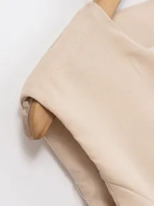Close-up detail of the sleeveless vest fabric, showing fine texture and stitching.