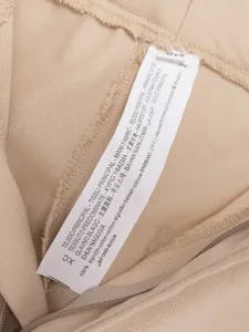 Fabric detail of women's sleeveless vest wide leg pants suit, 100% cotton material tag.