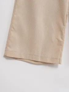 Beige wide leg pants detail view, premium fabric close-up, stylish commuter clothing.