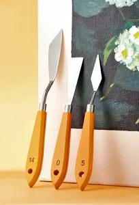 Detail shot of artist palette knives with wooden handles and metal blades for oil painting.