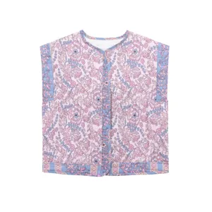 Close-up detail of the retro ethnic floral quilted vest, showing pink print and blue trim.