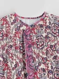 Detailed view of women vintage ethnic floral quilted vest, warm padded winter outerwear.