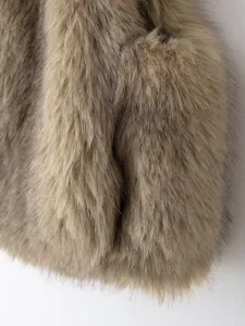 Close-up detail of stylish women's autumn faux fur vest jacket texture and fluffy material.