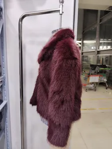 Detailed view of women's short faux fur fluffy winter coat in elegant burgundy retro style.