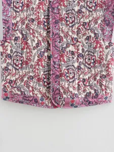 Detail view of women's vintage floral quilted vest, boho style cotton padded outerwear.