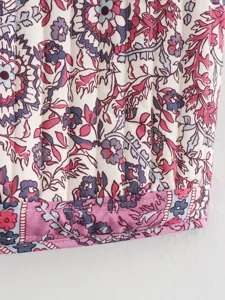 Detailed view of women's vintage floral quilted vest fabric, showing fine stitching.